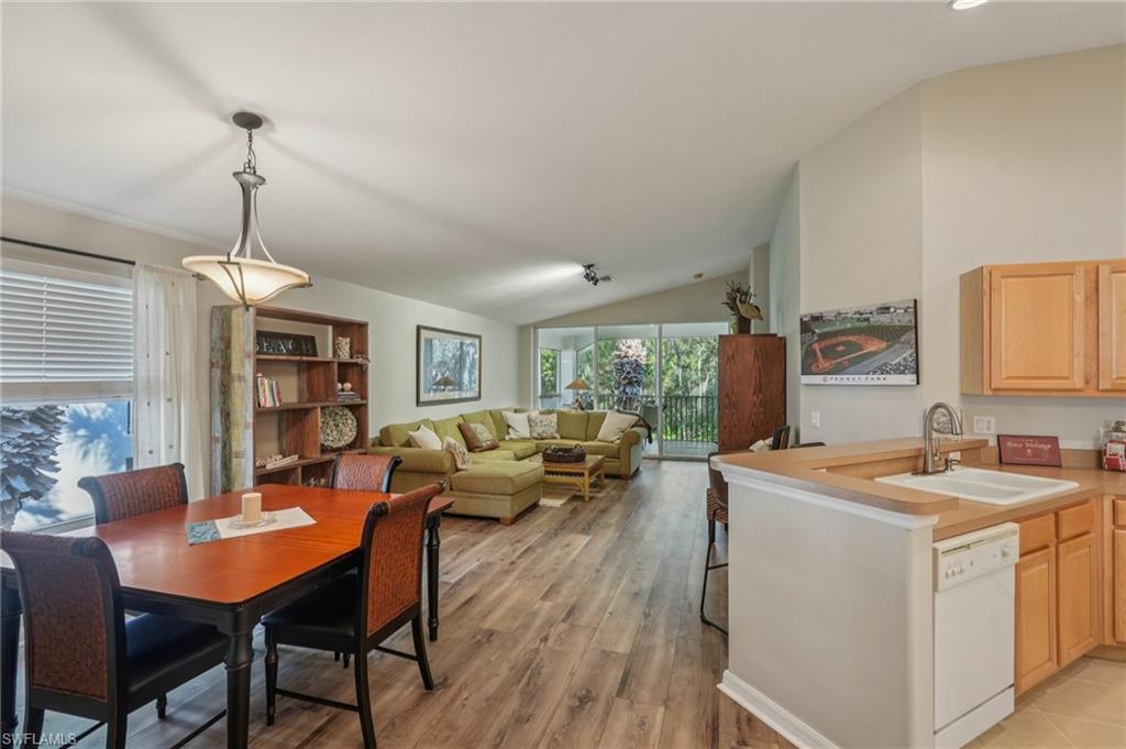 9583 Hemingway Lane, Unit 4309 Fort Myers, FL 33913 - Photo 2 of 18 a view of a dining room with furniture window and wooden floor
