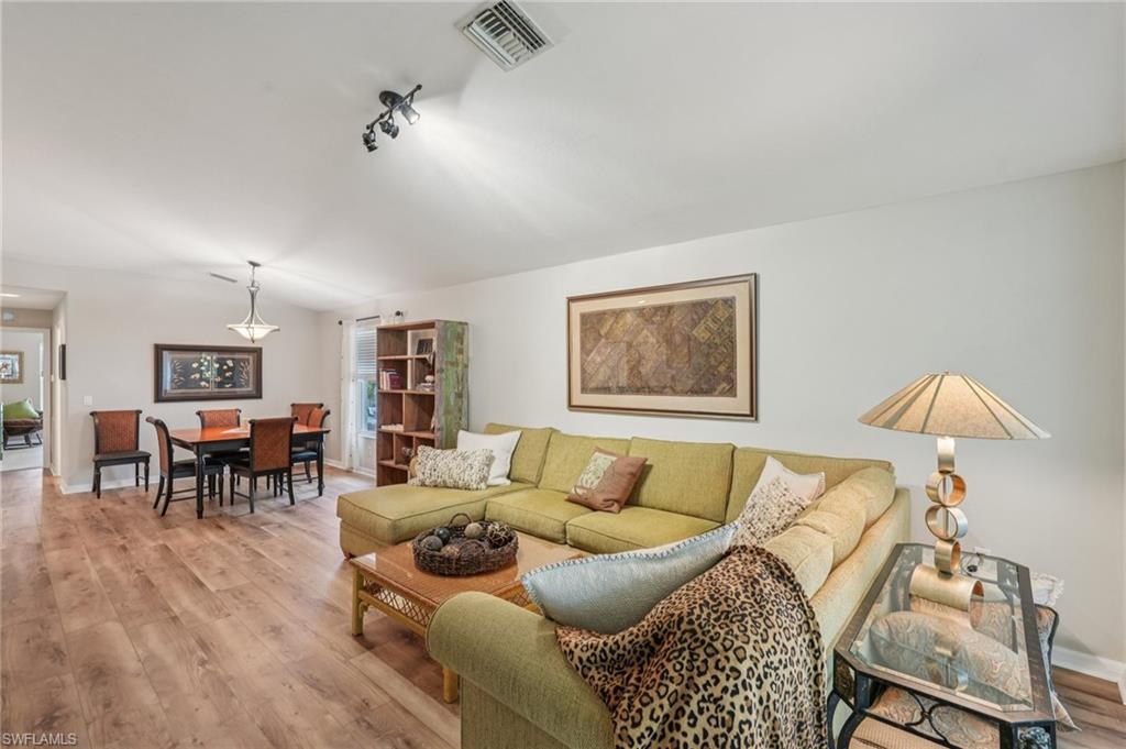 9583 Hemingway Lane, Unit 4309 Fort Myers, FL 33913 - Photo 3 of 18 a living room with furniture and a wooden floor
