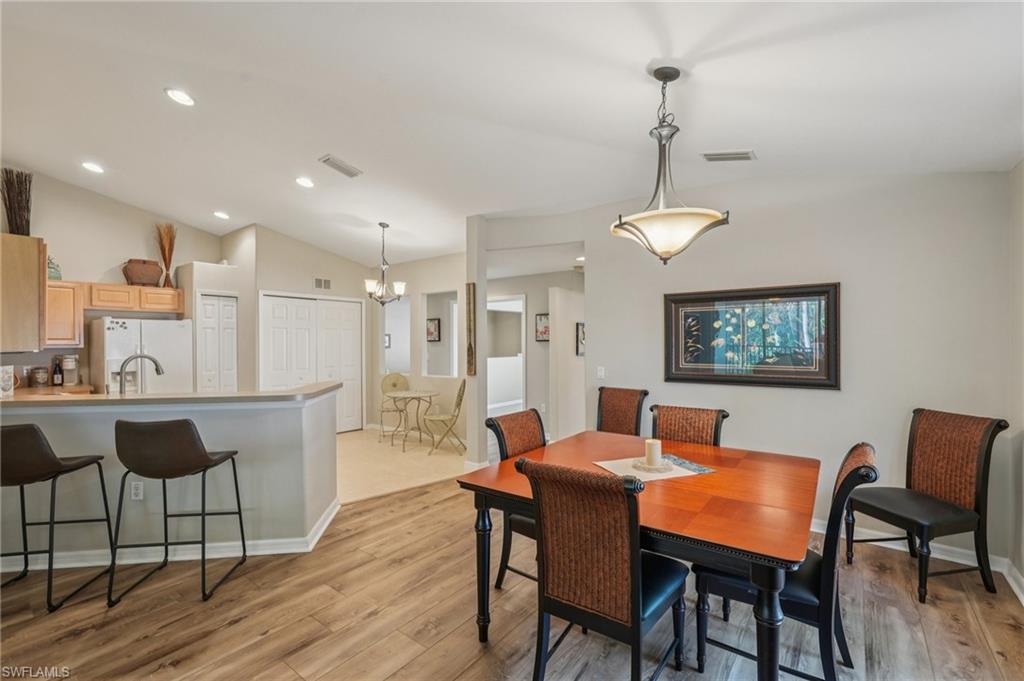 9583 Hemingway Lane, Unit 4309 Fort Myers, FL 33913 - Photo 4 of 18 a view of a a dining room with furniture window and wooden floor