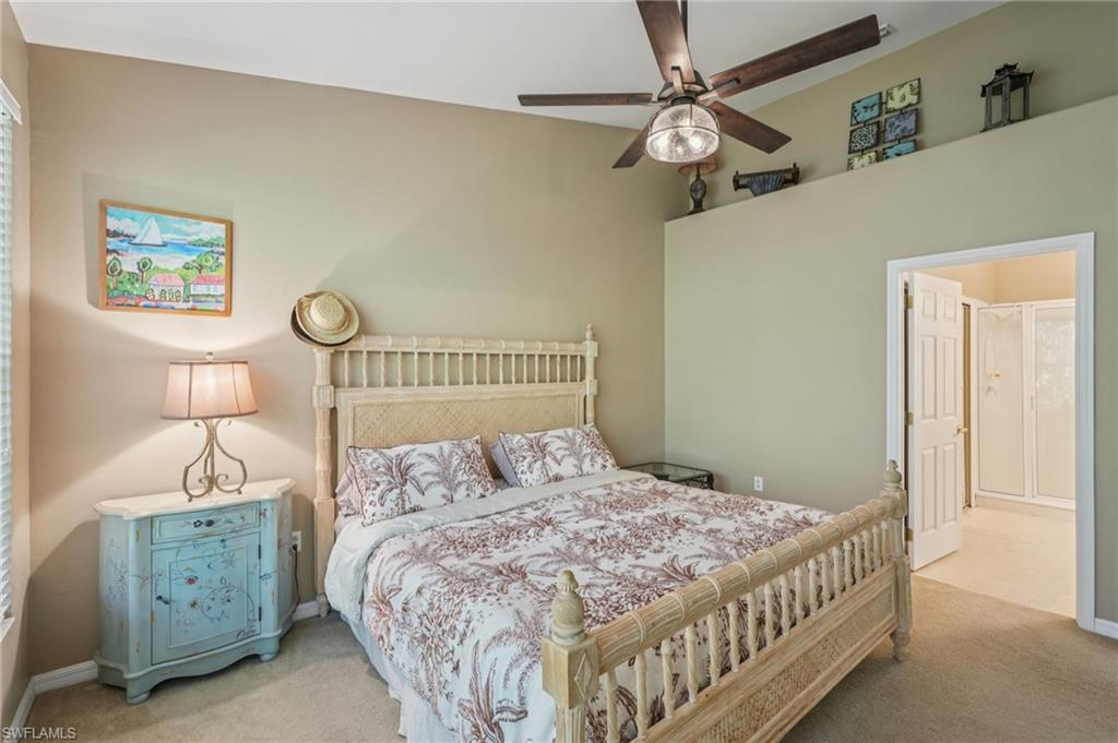 9583 Hemingway Lane, Unit 4309 Fort Myers, FL 33913 - Photo 9 of 18 a bedroom with a bed a bed and a chandelier