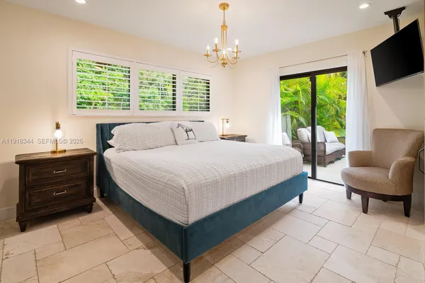 a bedroom with a bed and a couch
