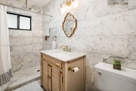 a bathroom with a sink a vanity and a mirror