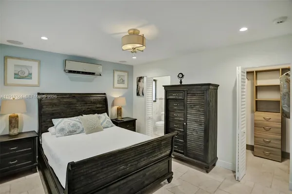 a bedroom with a bed and a television