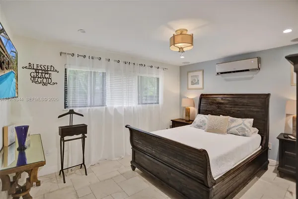 a bedroom with a bed and a chandelier