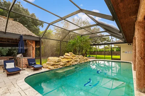 a view of a patio with table and chairs potted plants with a swimming pool