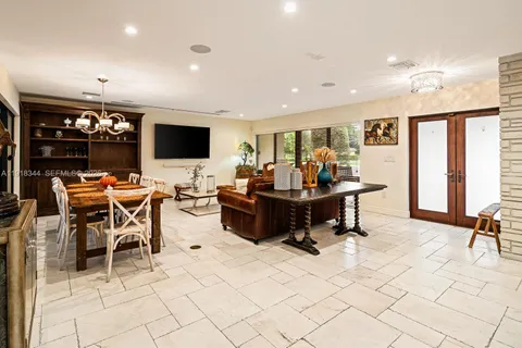 a living room with furniture a flat screen tv and a large window
