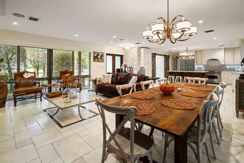 a view of a dining room and hall with furniture
