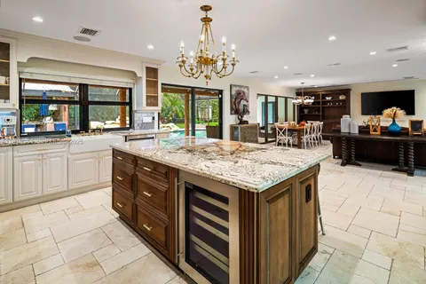 a kitchen with a stove top oven and sink
