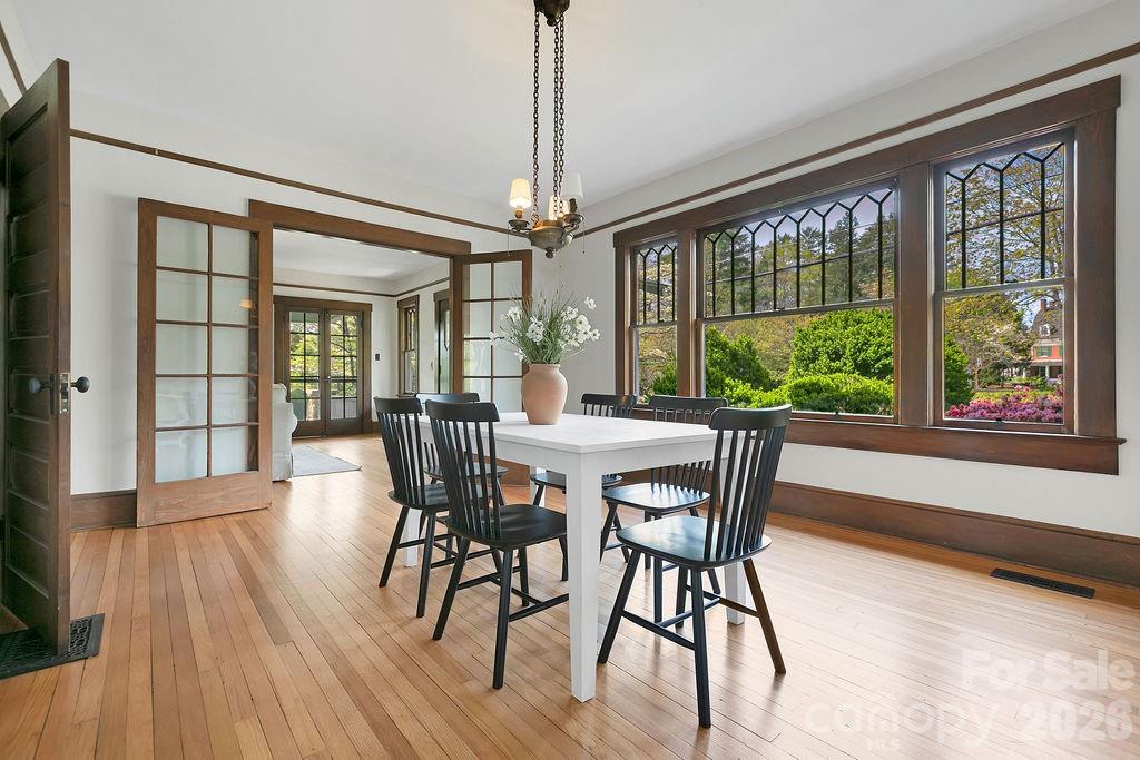 431 East Main Street Brevard, NC 28712 - Photo 16 of 45 a view of a dining room with furniture window and wooden floor