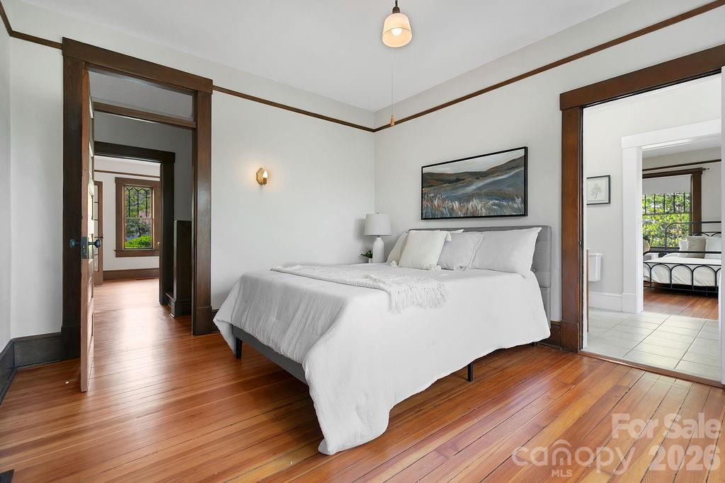431 East Main Street Brevard, NC 28712 - Photo 20 of 45 a bedroom with a large bed and a wooden floor