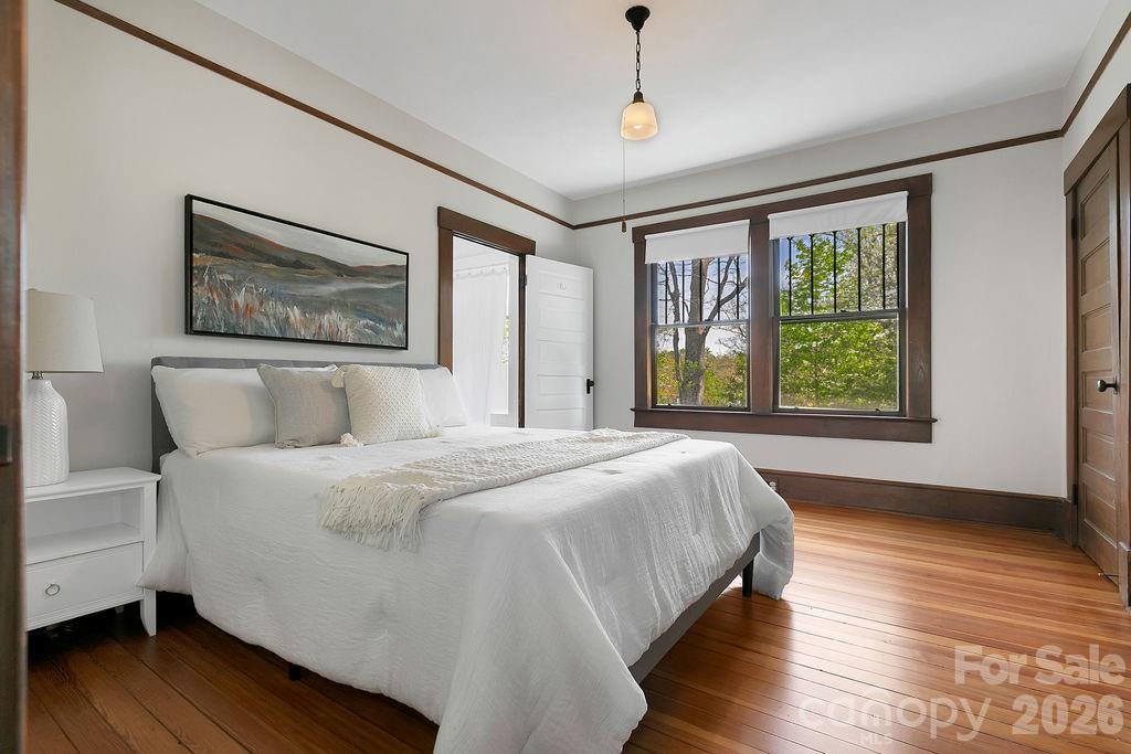 431 East Main Street Brevard, NC 28712 - Photo 21 of 45 a spacious bedroom with a large bed and a window