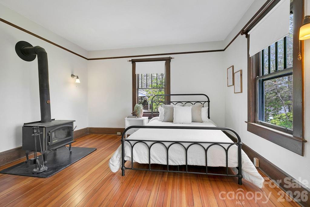 431 East Main Street Brevard, NC 28712 - Photo 24 of 45 a bedroom with a bed window and wooden floor