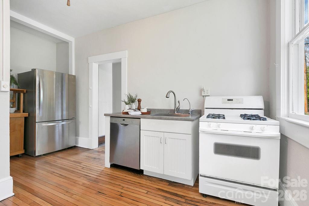 431 East Main Street Brevard, NC 28712 - Photo 26 of 45 a kitchen with a stove top oven and refrigerator