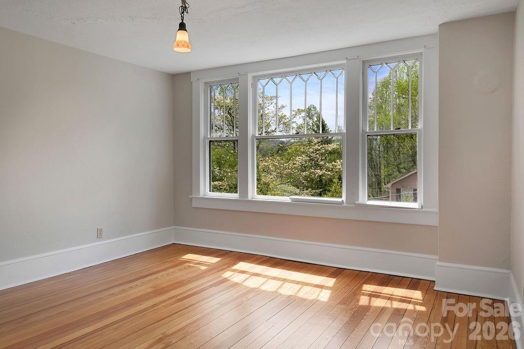 431 East Main Street Brevard, NC 28712 - Photo 35 of 45 a view of an empty room with wooden floor and a window