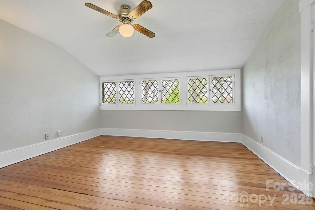 431 East Main Street Brevard, NC 28712 - Photo 36 of 45 an empty room with wooden floor fan and windows