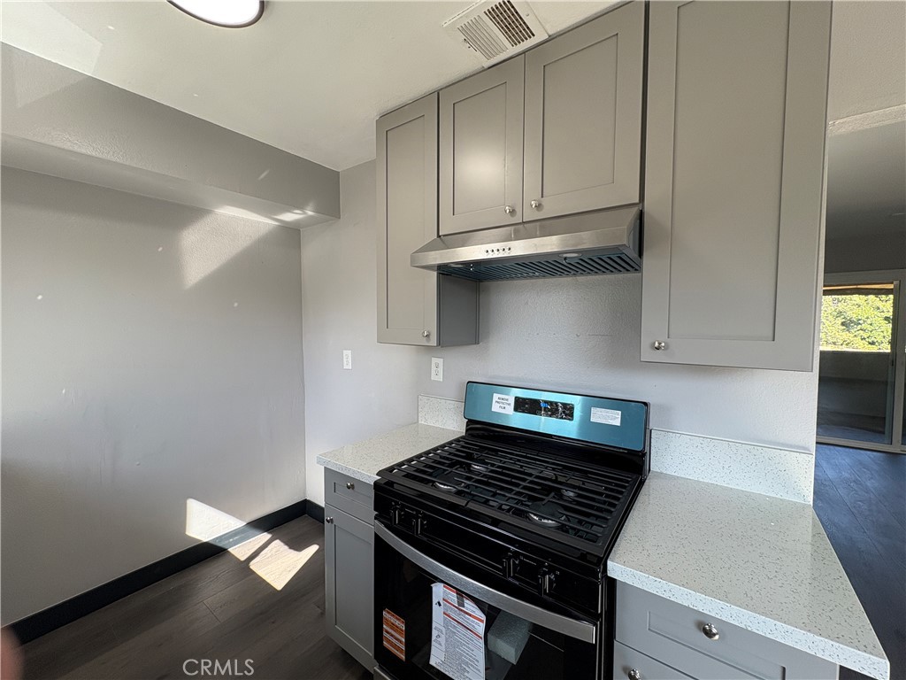2826 Cogswell Road, Unit A #M El Monte, CA 91732 - Photo 23 of 55 a kitchen with granite countertop a stove and a cabinets