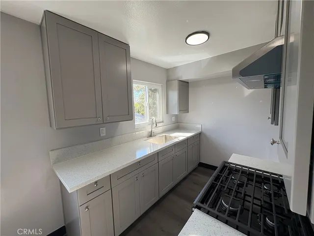 a kitchen with a sink cabinets and utility