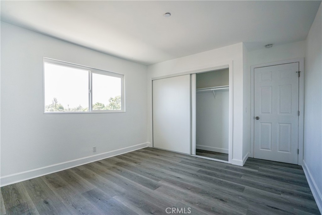 2826 Cogswell Road, Unit A #M El Monte, CA 91732 - Photo 53 of 55 an empty room with wooden floor and windows