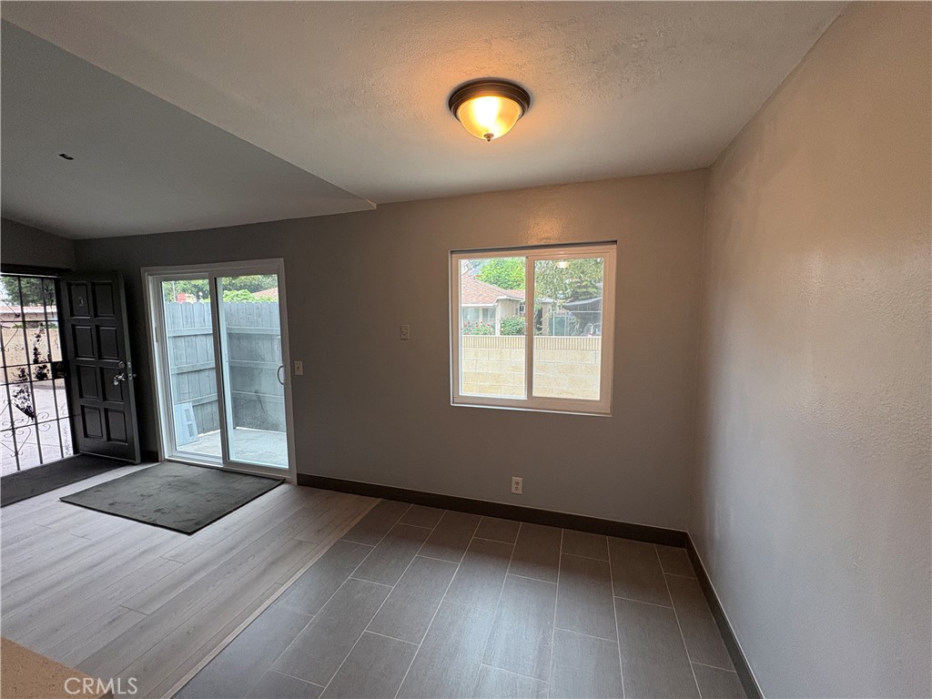 2826 Cogswell Road, Unit A #M El Monte, CA 91732 - Photo 8 of 55 an empty room with wooden floor and windows