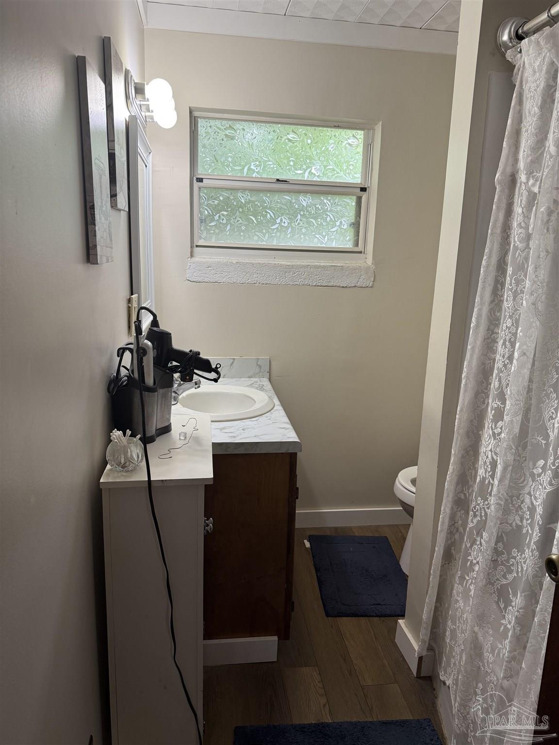3971 Highway 4 Jay, FL 32565 - Photo 16 of 19 a bathroom with a sink a toilet and mirror