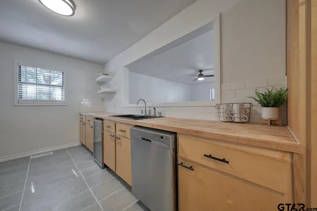 a utility room with cabinets washer and dryer