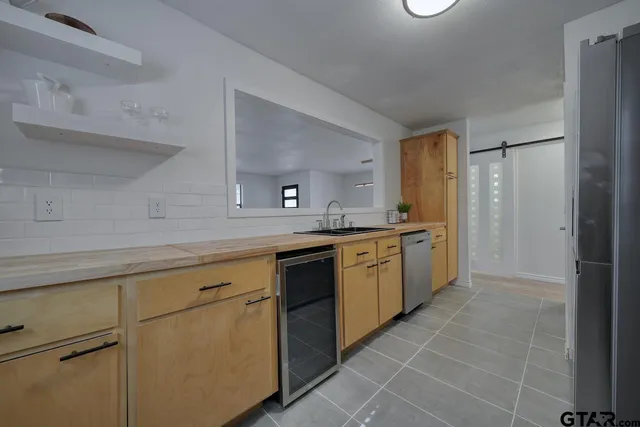a kitchen with a sink cabinets and refrigerator