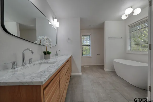a bathroom with a sink vanity and mirror