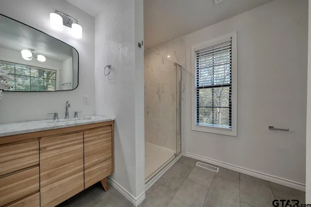 a bathroom with a bathtub sink and mirror