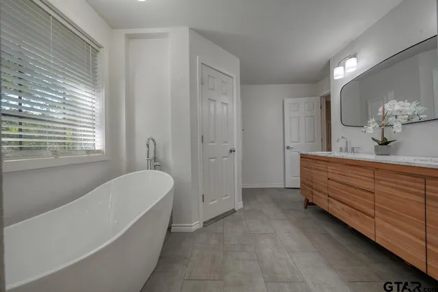 a view of a livingroom with wooden floor and furniture
