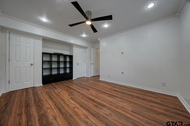 an aerial view of residential house with outdoor space and trees all around