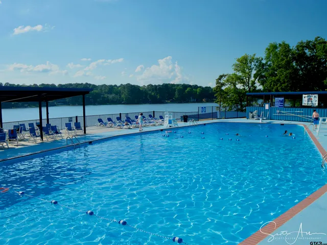 a view of an house with a big yard and palm trees