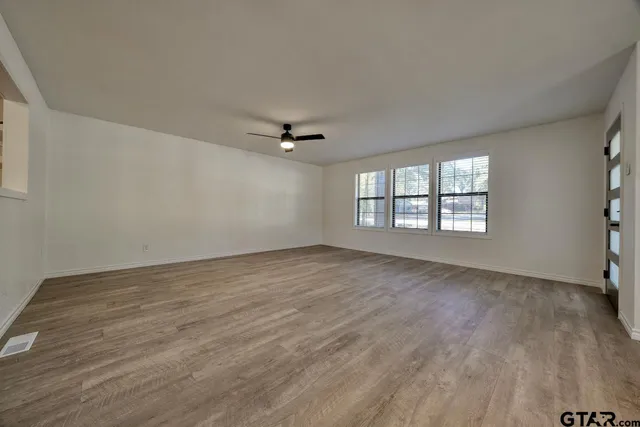 wooden floor in an empty room with a window