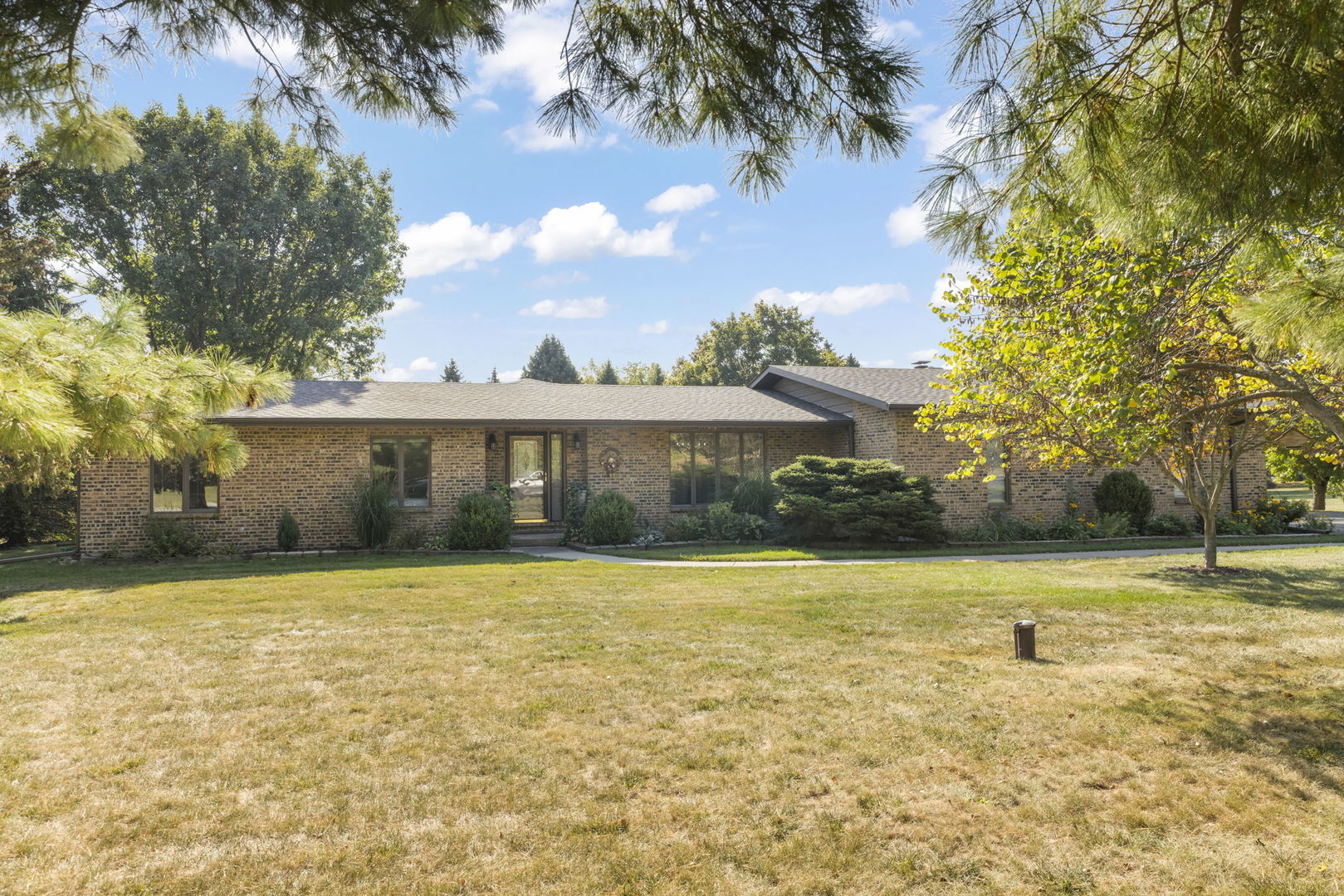 a front view of a house with a yard
