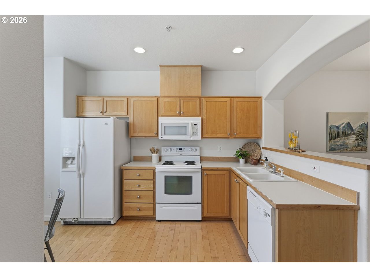 15450 Southwest Sparrow Loop, Unit 102 Beaverton, OR 97007 - Photo 11 of 27 a kitchen with a stove a sink and a refrigerator