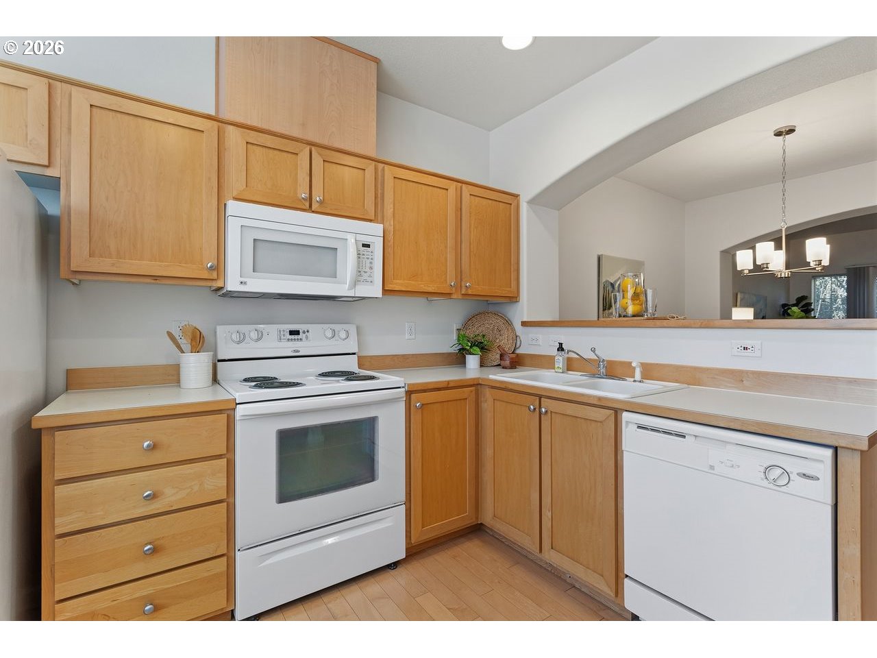 15450 Southwest Sparrow Loop, Unit 102 Beaverton, OR 97007 - Photo 12 of 27 a kitchen with cabinets stainless steel appliances and a sink