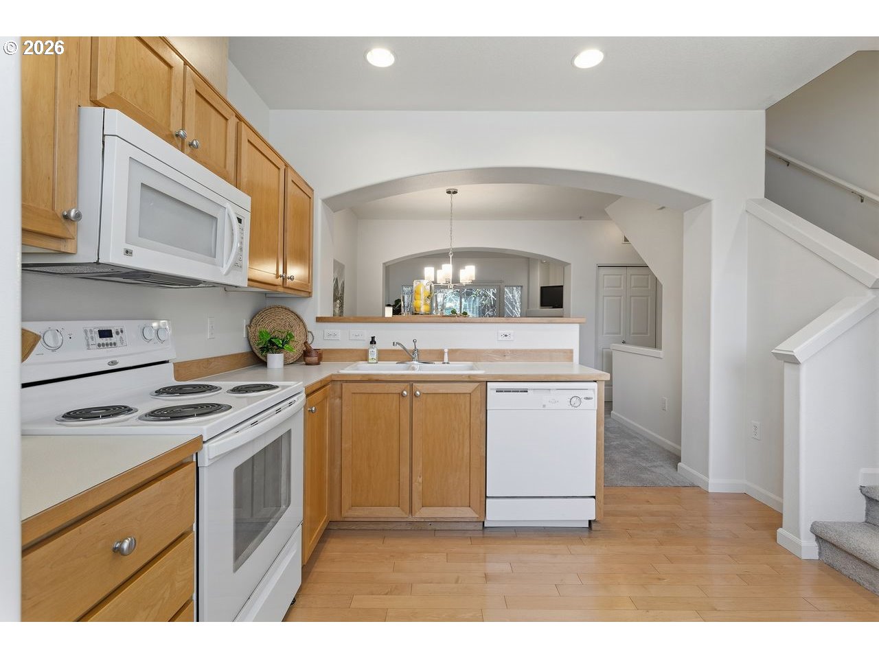 15450 Southwest Sparrow Loop, Unit 102 Beaverton, OR 97007 - Photo 13 of 27 a kitchen with a stove cabinets and a sink
