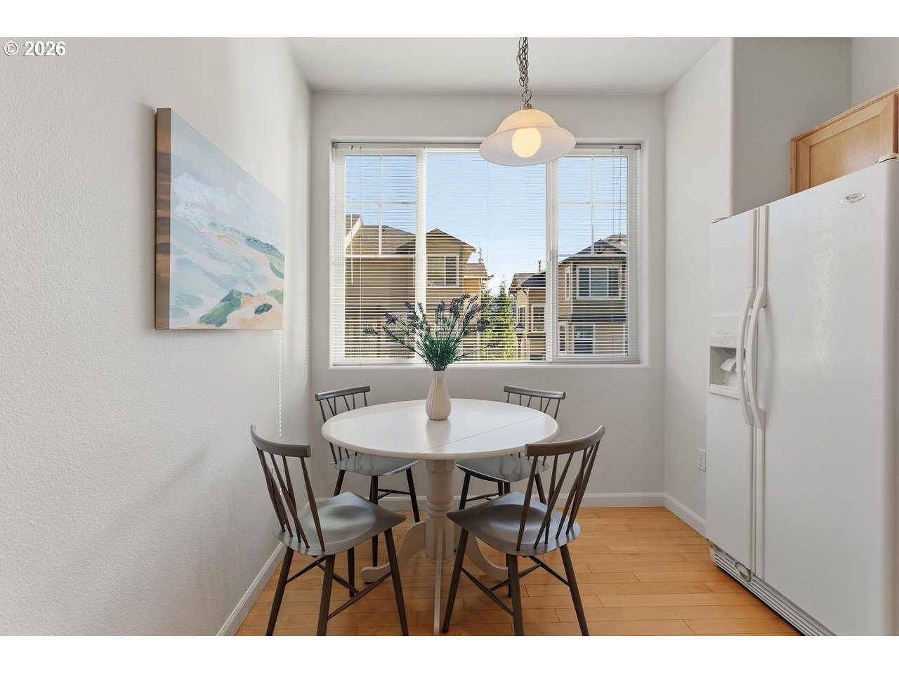 15450 Southwest Sparrow Loop, Unit 102 Beaverton, OR 97007 - Photo 14 of 27 a view of a dining room with furniture and a chandelier