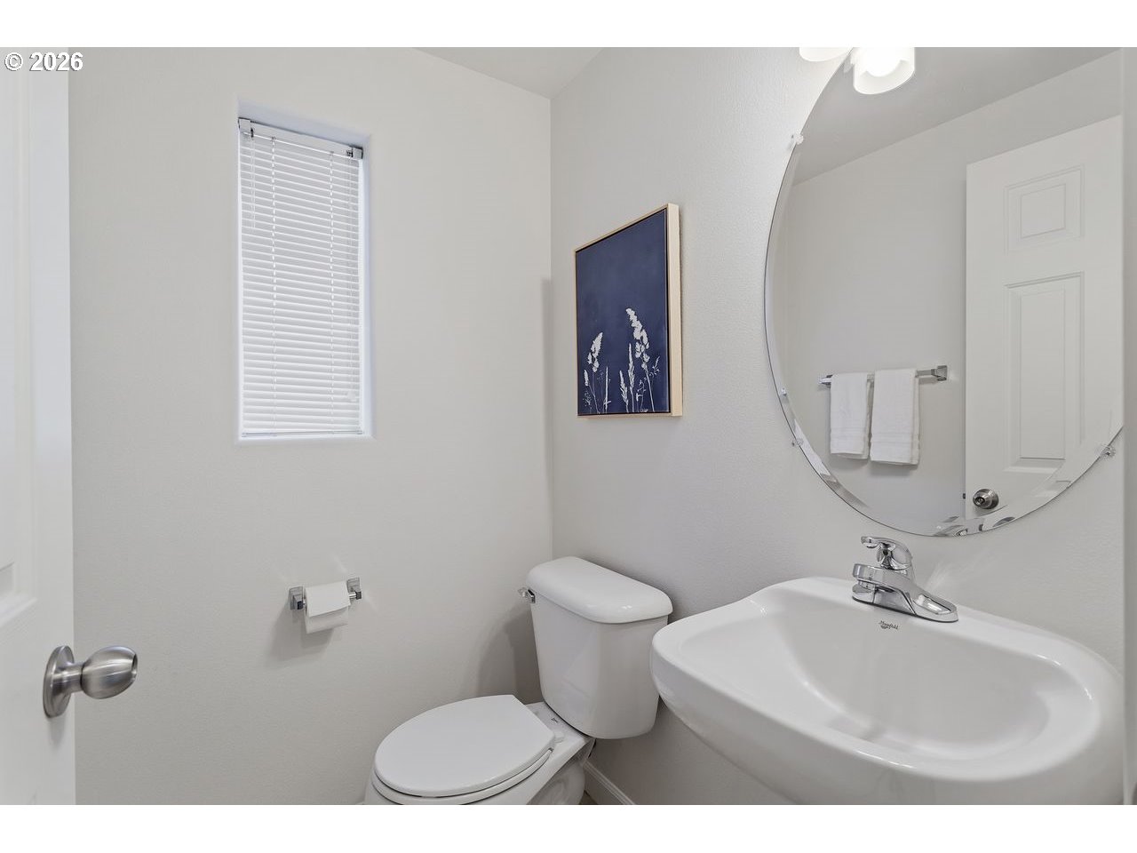 15450 Southwest Sparrow Loop, Unit 102 Beaverton, OR 97007 - Photo 15 of 27 a bathroom with a toilet sink and mirror