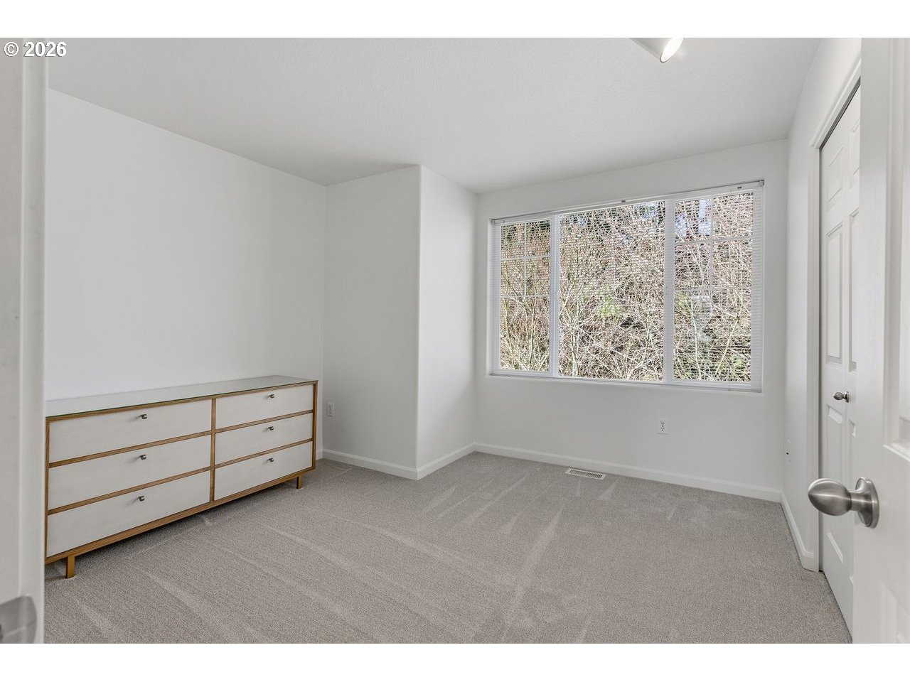 15450 Southwest Sparrow Loop, Unit 102 Beaverton, OR 97007 - Photo 16 of 27 a view of room with window and hardwood floor
