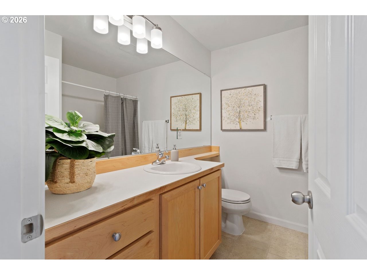 15450 Southwest Sparrow Loop, Unit 102 Beaverton, OR 97007 - Photo 18 of 27 a bathroom with a sink a toilet and mirror