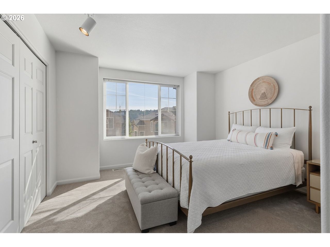 15450 Southwest Sparrow Loop, Unit 102 Beaverton, OR 97007 - Photo 19 of 27 a bedroom with a bed and a window