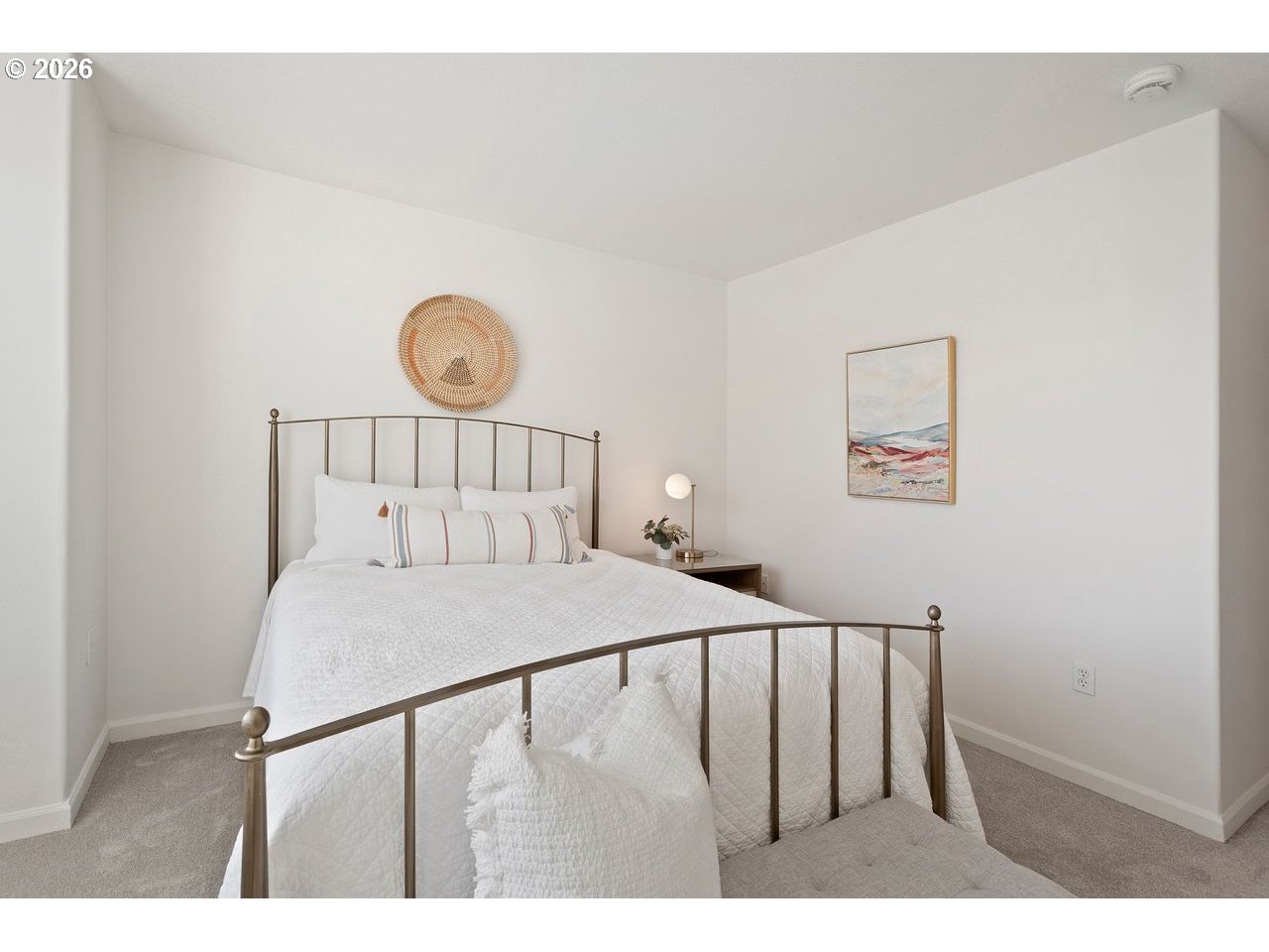 15450 Southwest Sparrow Loop, Unit 102 Beaverton, OR 97007 - Photo 20 of 27 a bedroom with a bed and a window