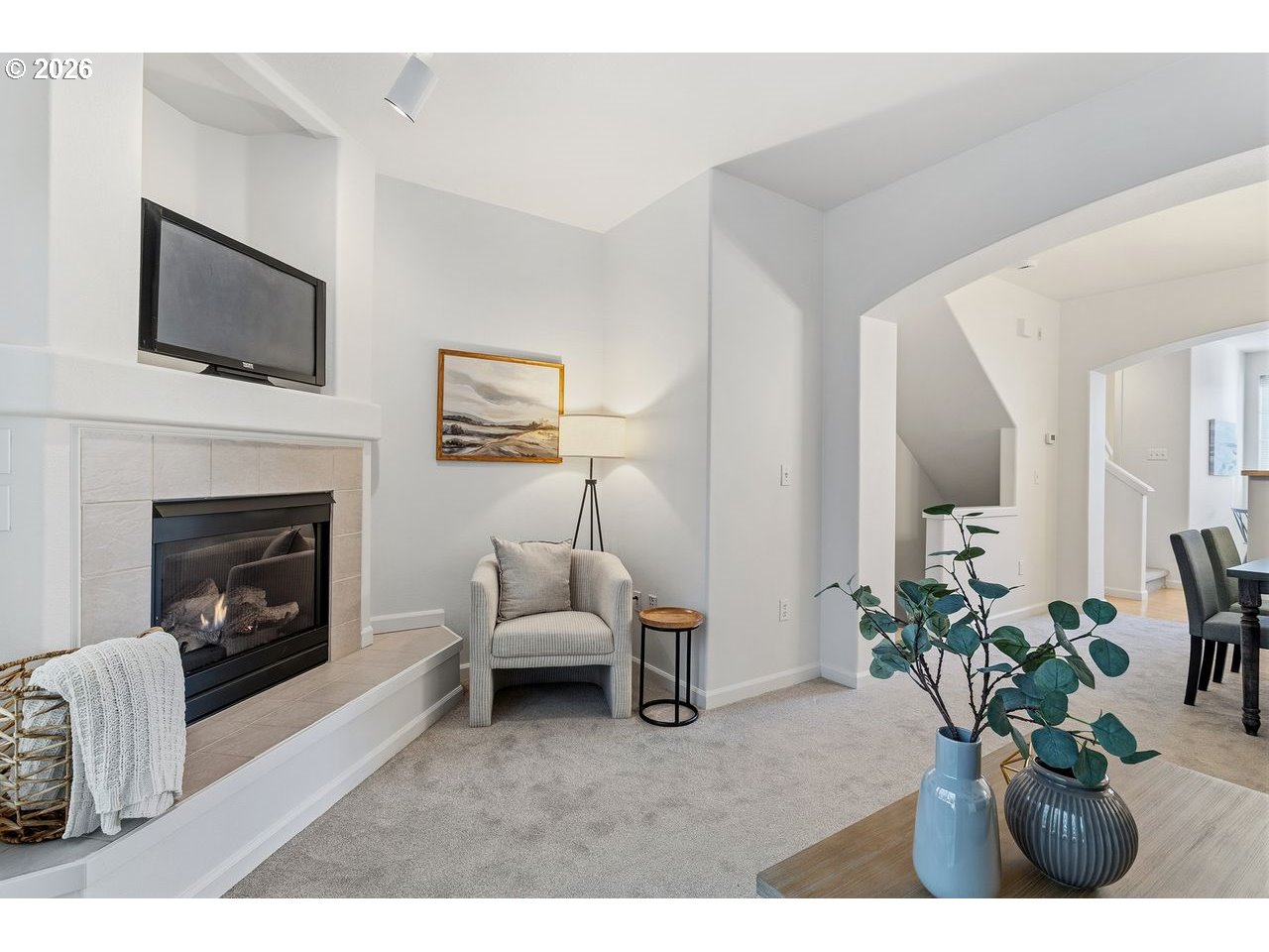 15450 Southwest Sparrow Loop, Unit 102 Beaverton, OR 97007 - Photo 5 of 27 a living room with furniture a flat screen tv and a fireplace