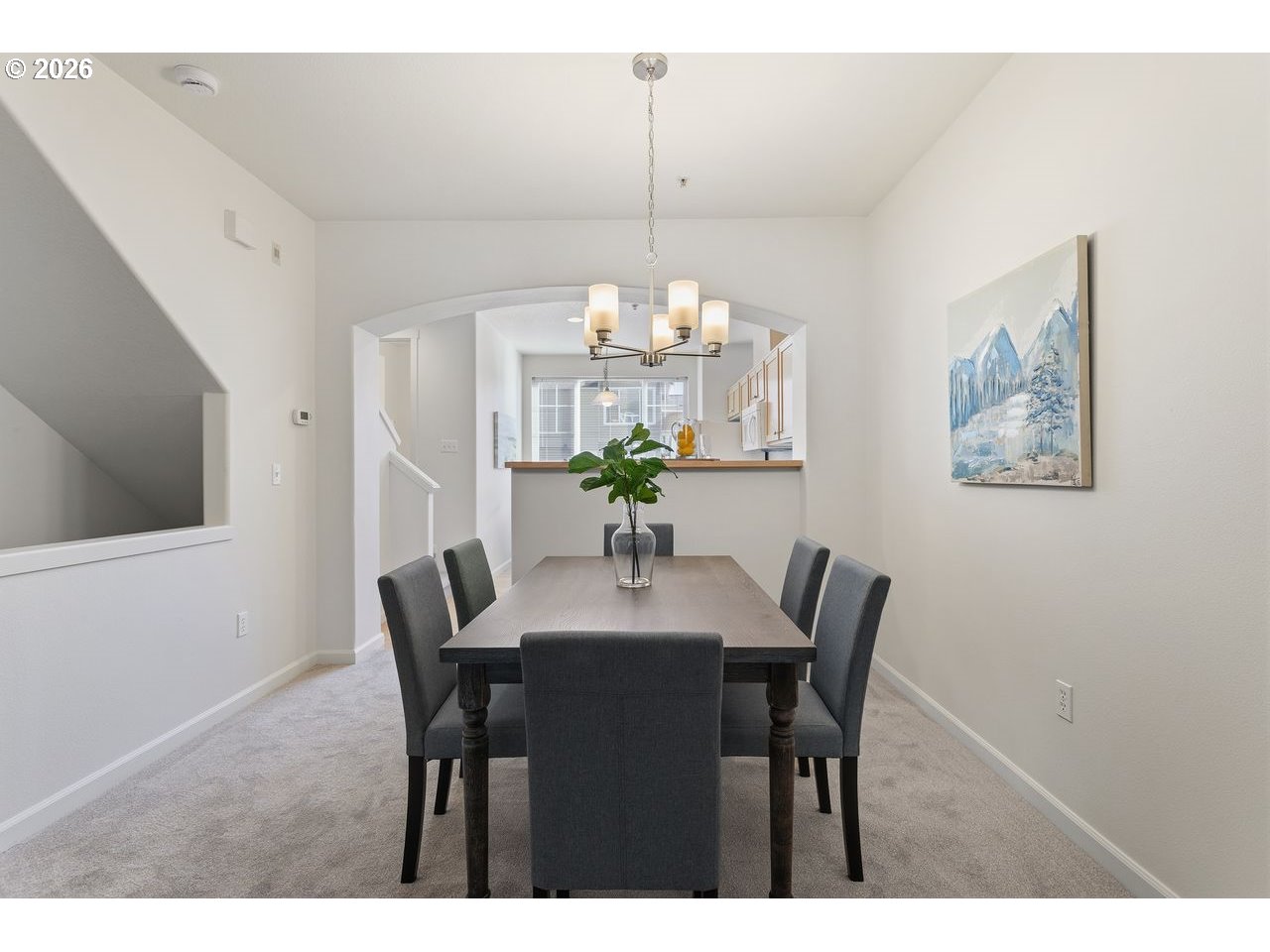 15450 Southwest Sparrow Loop, Unit 102 Beaverton, OR 97007 - Photo 8 of 27 a view of a dining room with furniture and chandelier