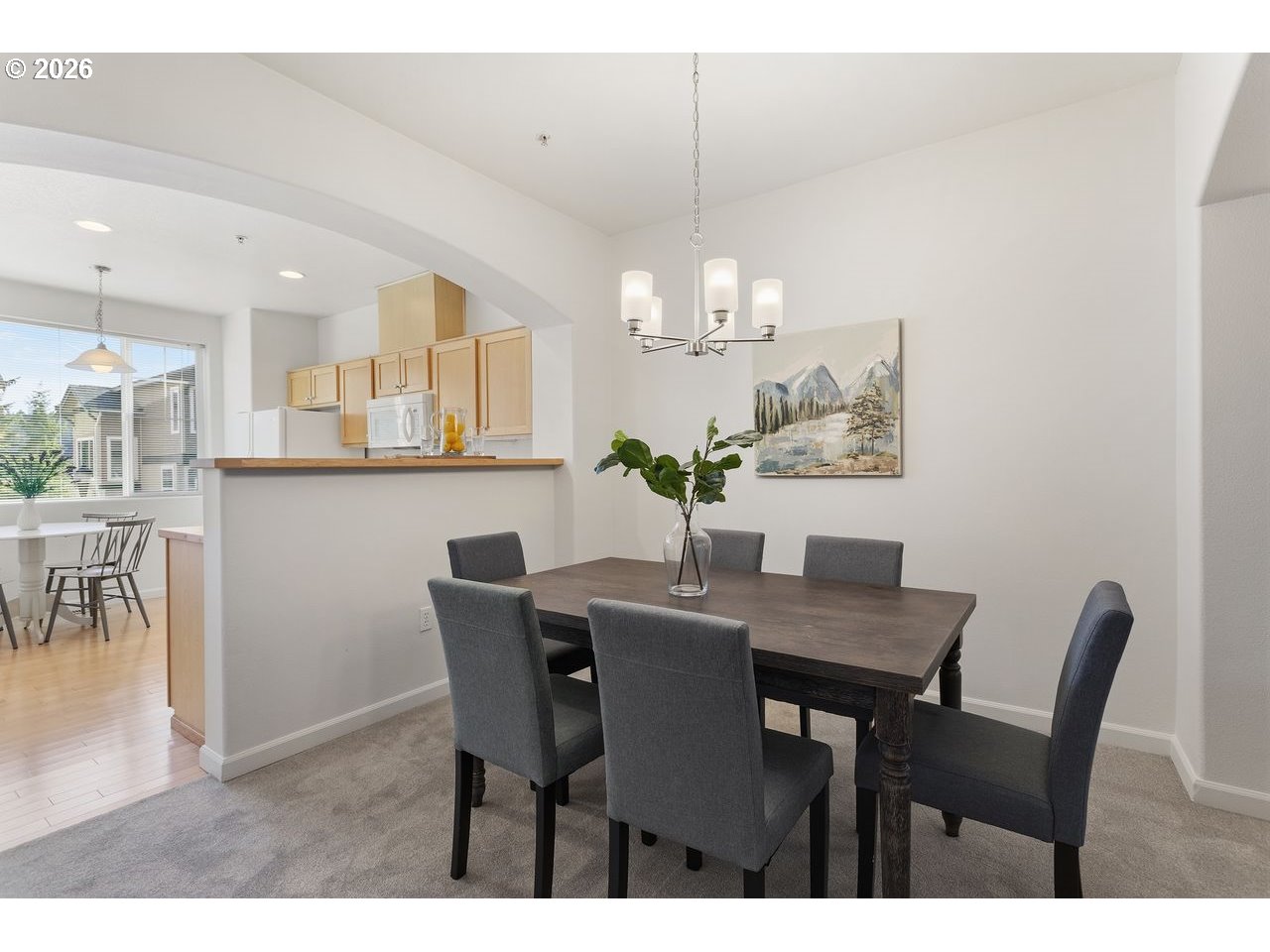 15450 Southwest Sparrow Loop, Unit 102 Beaverton, OR 97007 - Photo 9 of 27 a view of a dining room with furniture and chandelier