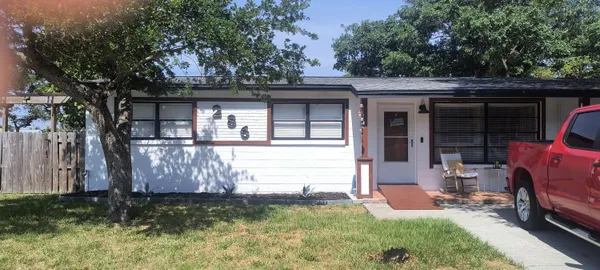 a front view of a house with garden