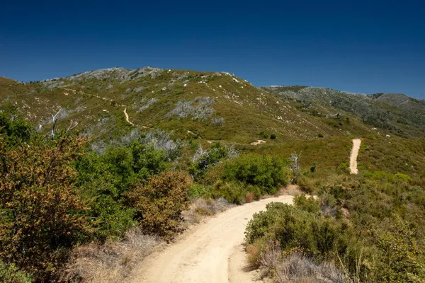 a view of a large mountain with mountains in the background