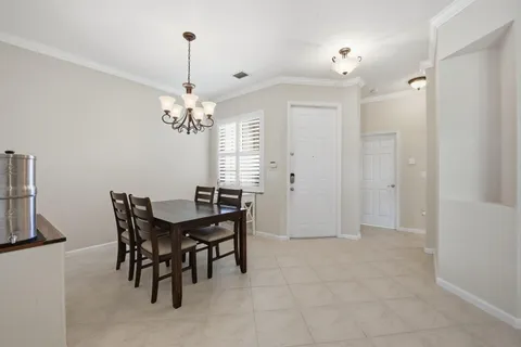 a view of a dining room with furniture and chandelier