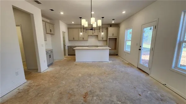 a kitchen with stainless steel appliances kitchen island a refrigerator and a stove