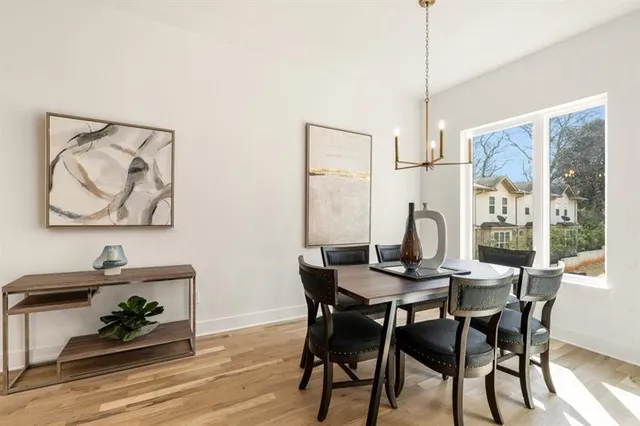 a view of a dining room with furniture window and wooden floor